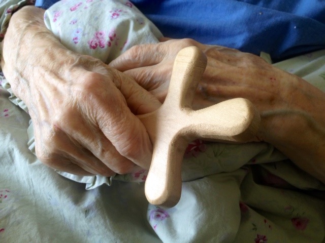 Roald Kverndal holds his new, hand-carved cross.