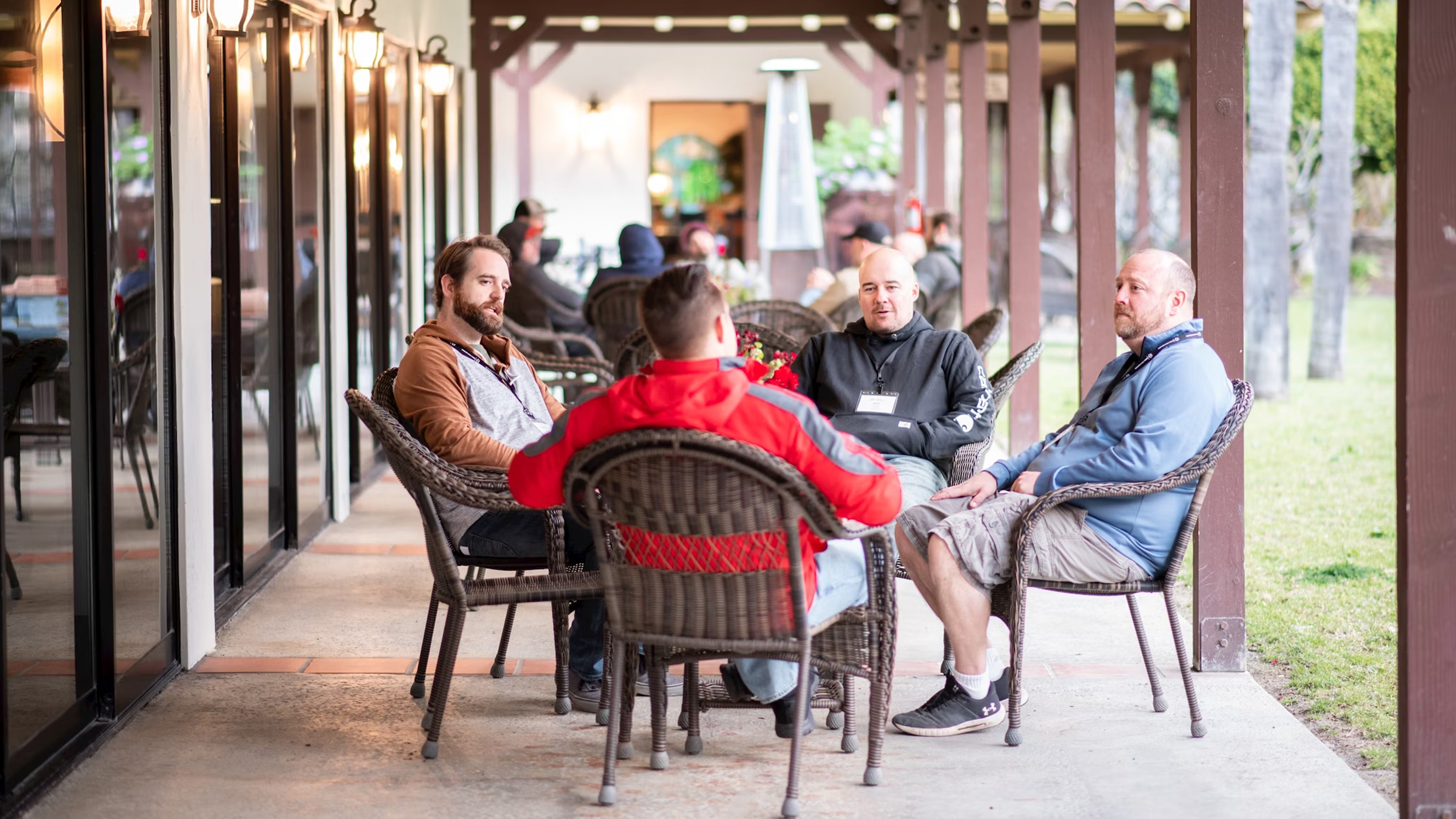 Group of men discussing around a table.