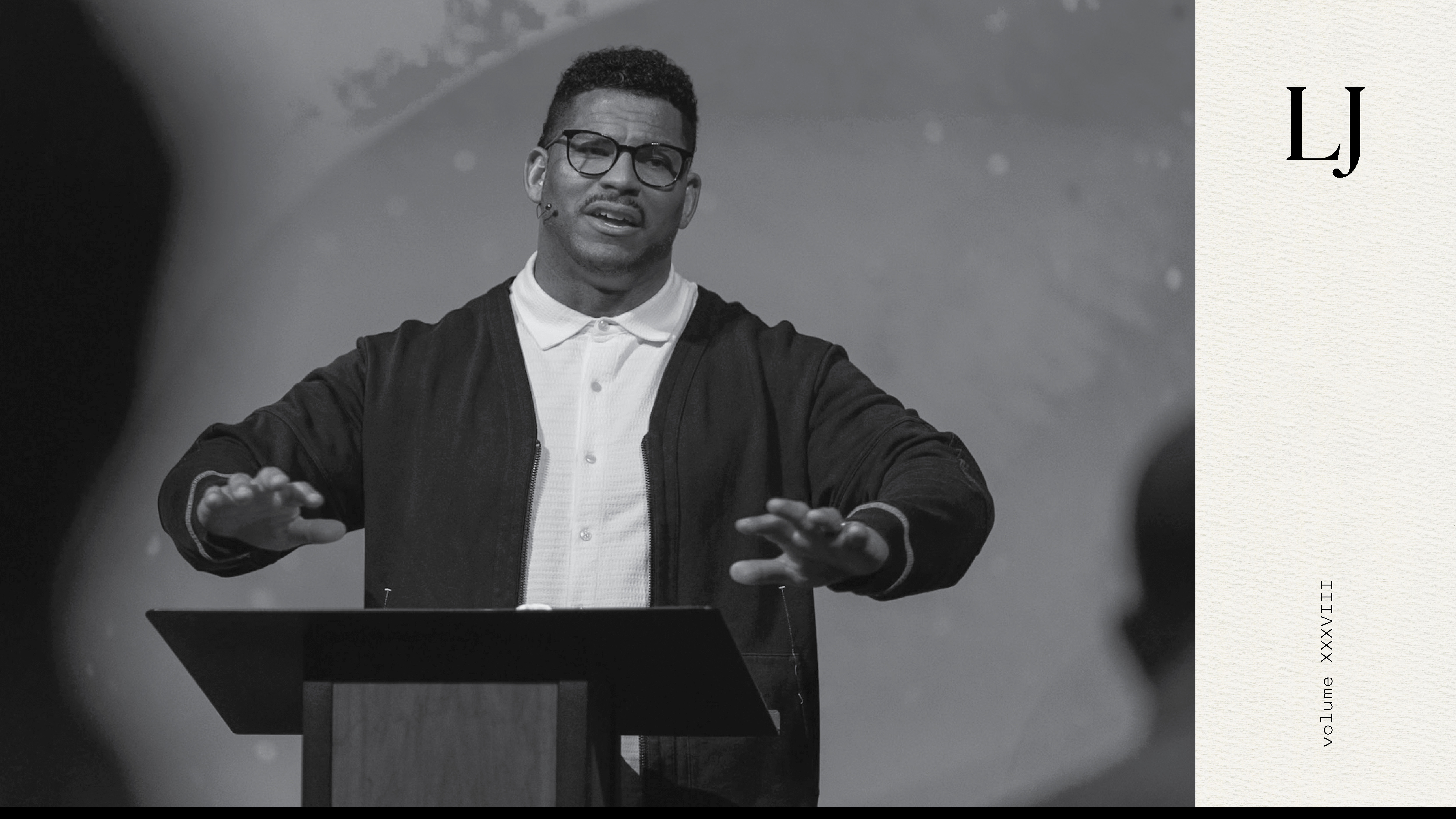 Black and white photo of Eddie Williams preaching at Doxa Church