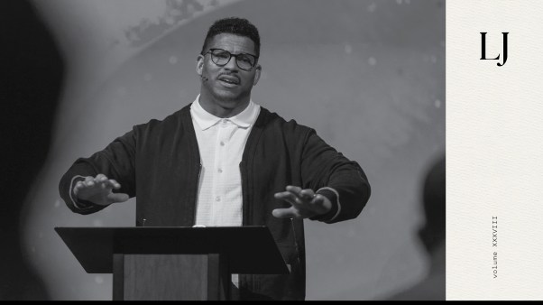 Black and white photo of Eddie Williams preaching at Doxa Church