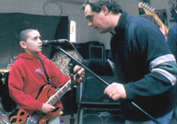 12-year-old C.J., a guitar whiz, gets instruction from Green