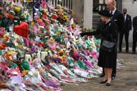 The Queen and Prince Phillip look at the flowers from Di's admirers
