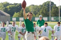 Lengyel holds a football aloft while giving a pep talk to the young Thundering Herd