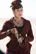 Anjelica Houston as traveling saleswoman Madame Louise