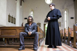 Syracuse meets with the priest (Stephen Rea)