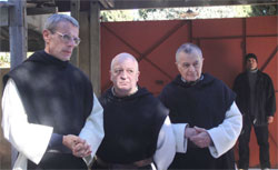 Christian, Paul (Jean-Marie Frin) and Celestin (Philippe Laudenbach) speak with the terrorists