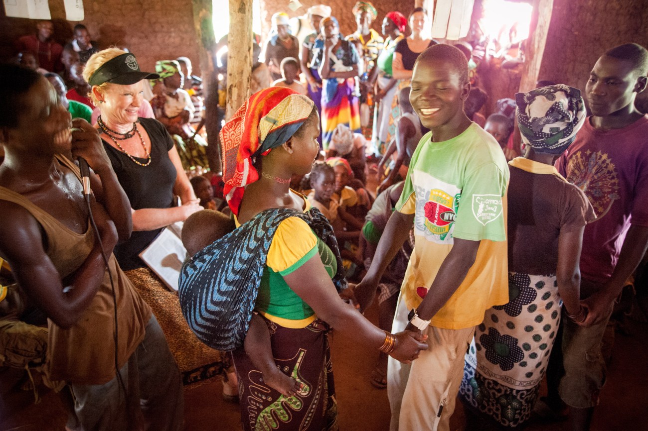 Baker officiates a wedding of several couples during a village outreach.