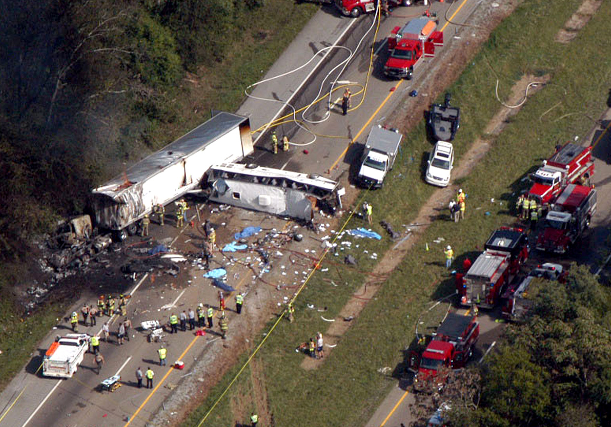 Emergency workers respond to a crash involving a passenger bus and a tractor-trailer near Dandridge, Tenn., on Wednesday, Oct. 2, 2013. The bus, which was carrying members of the Front Street Baptist Church in Statesville, N.C., blew a tire, veered across the highway median and hit a sport utility vehicle and the tractor-trailer.