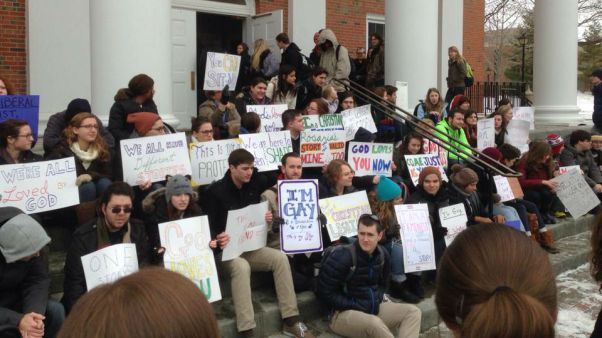 Demonstrators sit on steps of Edman Chapel.