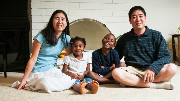 Grace and Matt Huang with two of their three adopted children.