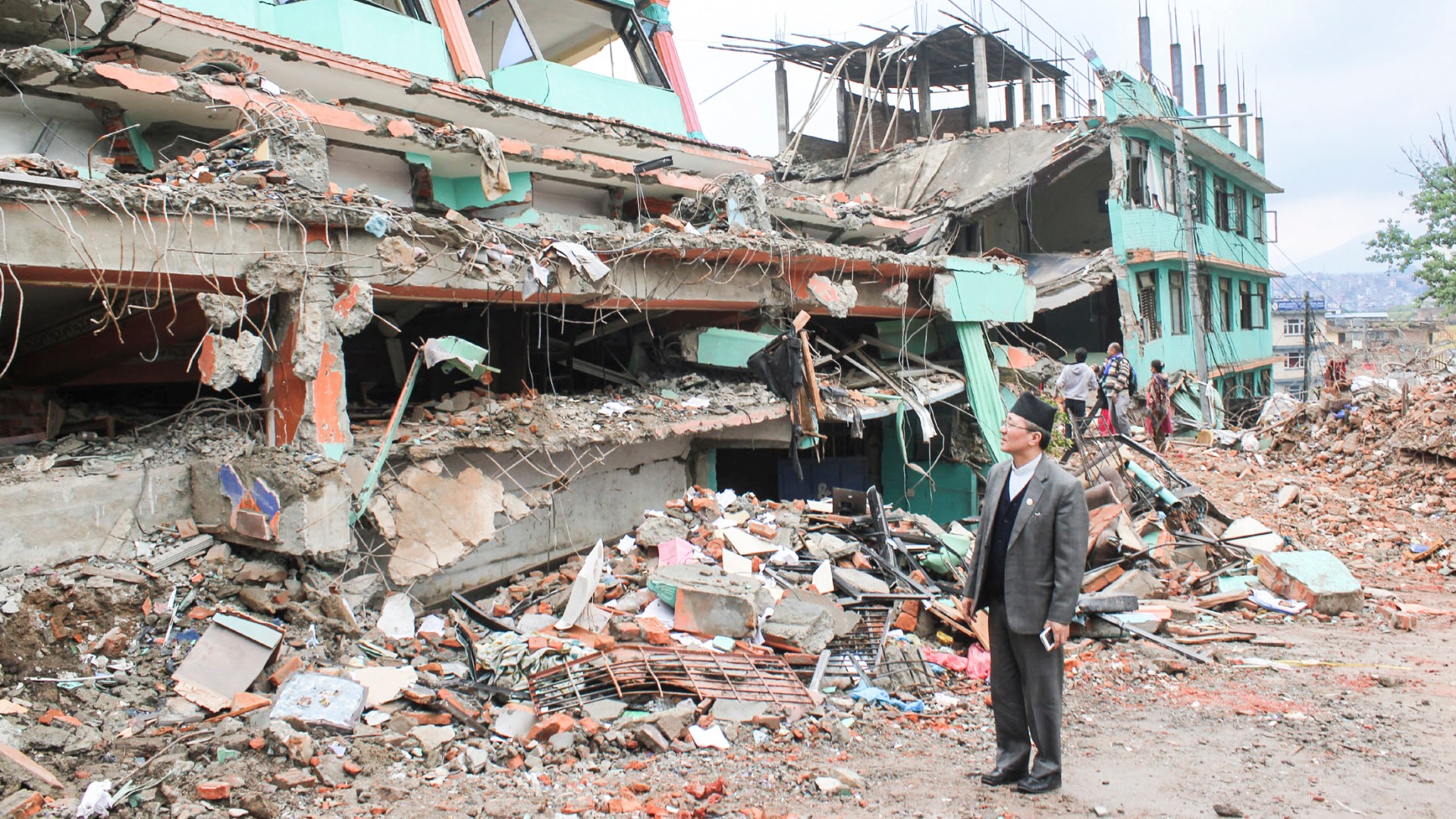 Catholic leader Paul Simick surveys wreckage of Pentecostal church in Kathmandu.