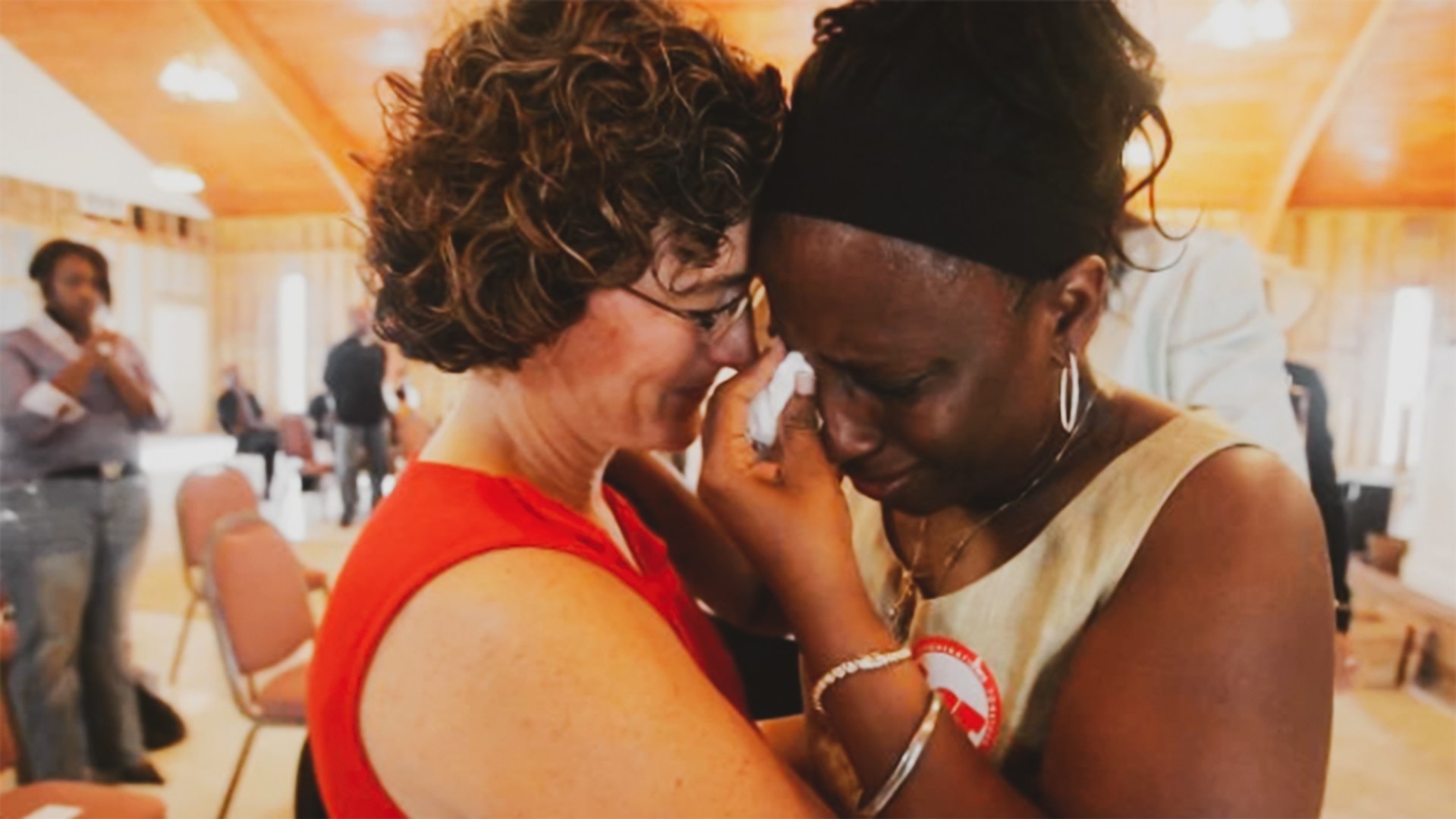 In the Lower Ninth Ward of New Orleans, a church volunteer (left) comforts Mary Croom-Fontenot at her Baptist church one year after Katrina.