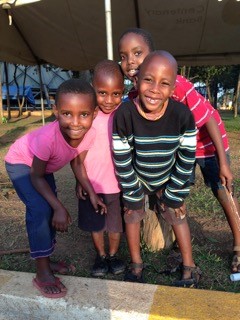  A group of children play and pose for a photograph at the Catholic Martyrs' Shrine.