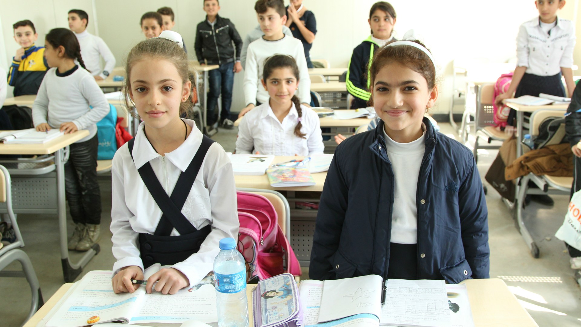 Myriam and her friend Sandra attend school in the refugee camp.