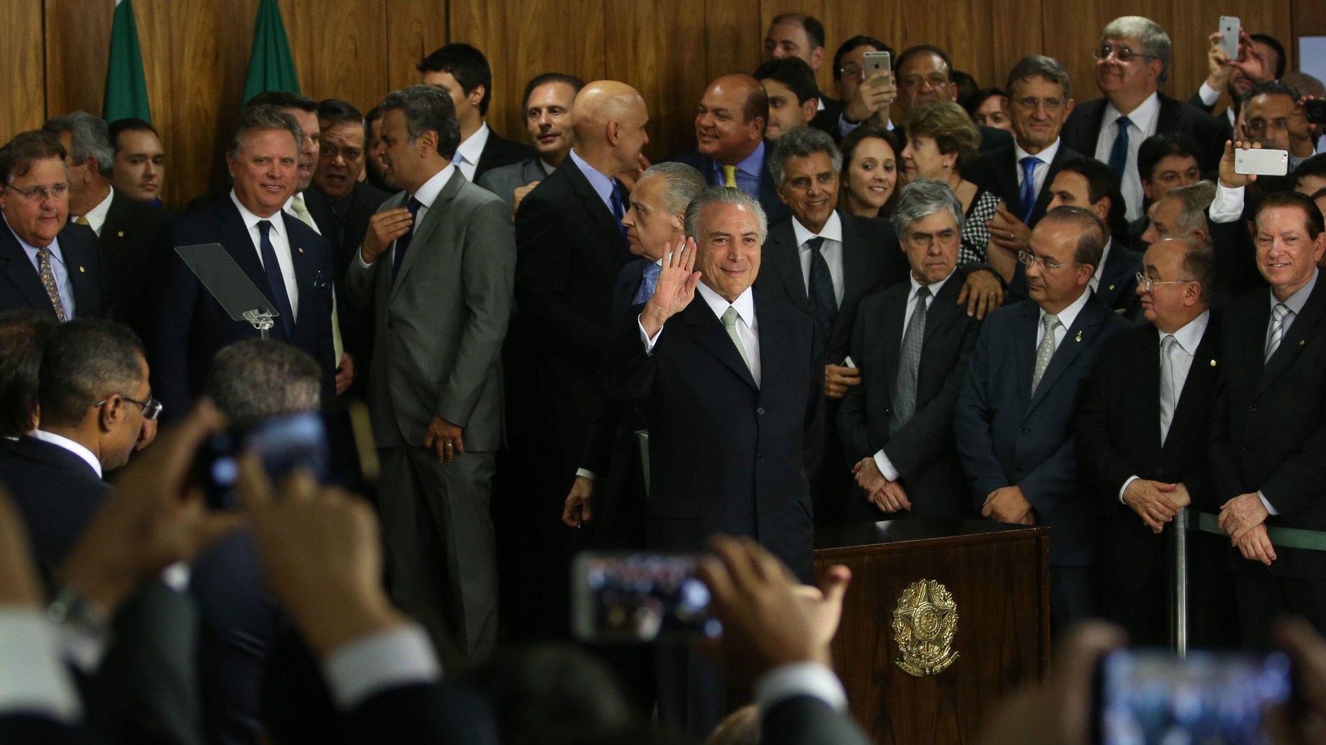 Interim president Michel Temer waves to supporters in Brazil.