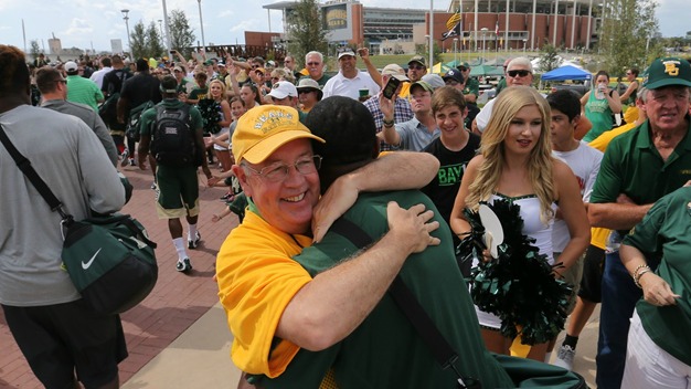 Ken Starr greets the Baylor Bears football team at McLane Stadium.