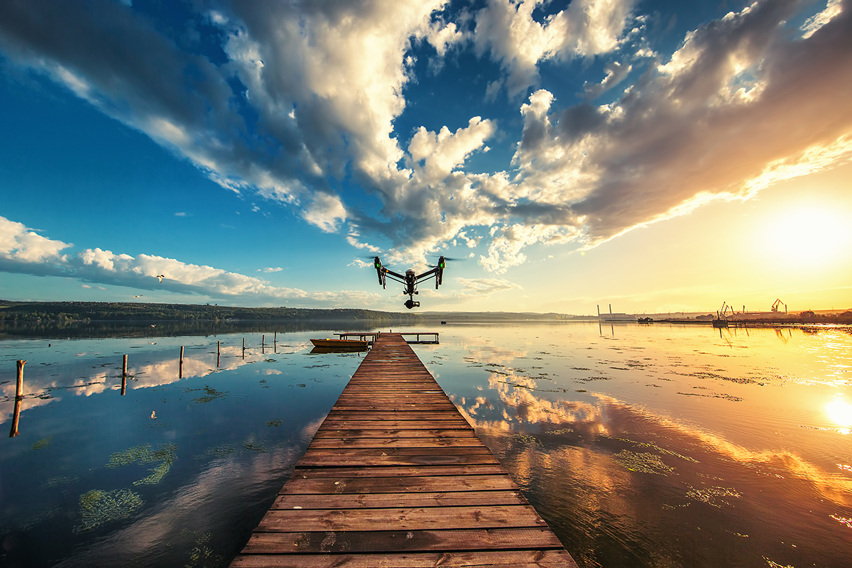 A quadcopter drone hovers over a lake in Varna, Bulgaria.