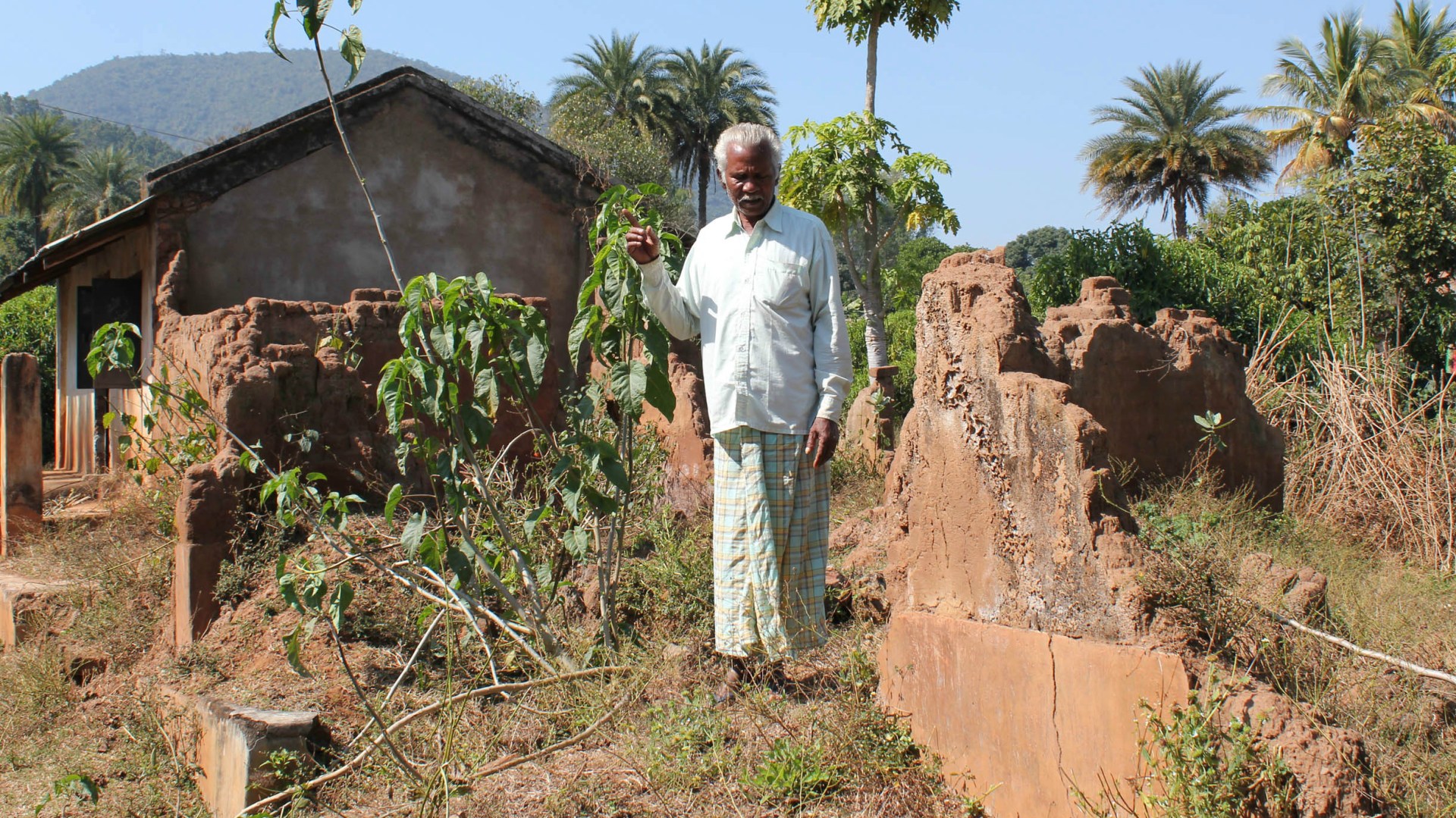 Obseswar Nayak  stands on the remains of his property in Borimunda village, Kandhamal.