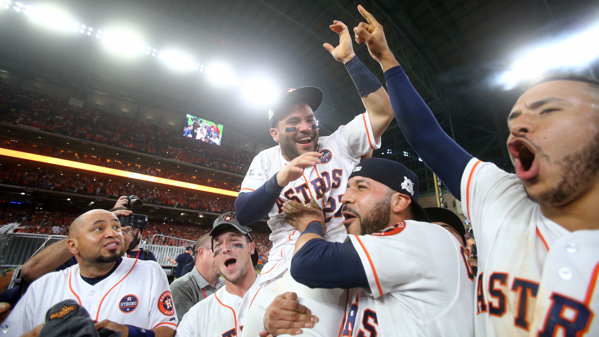 Jose Altuve of the Houston Astros celebrates with Marwin Gonzalez, Carlos Correa, and the rest of his team after the win at home that sent them to the World Series. 