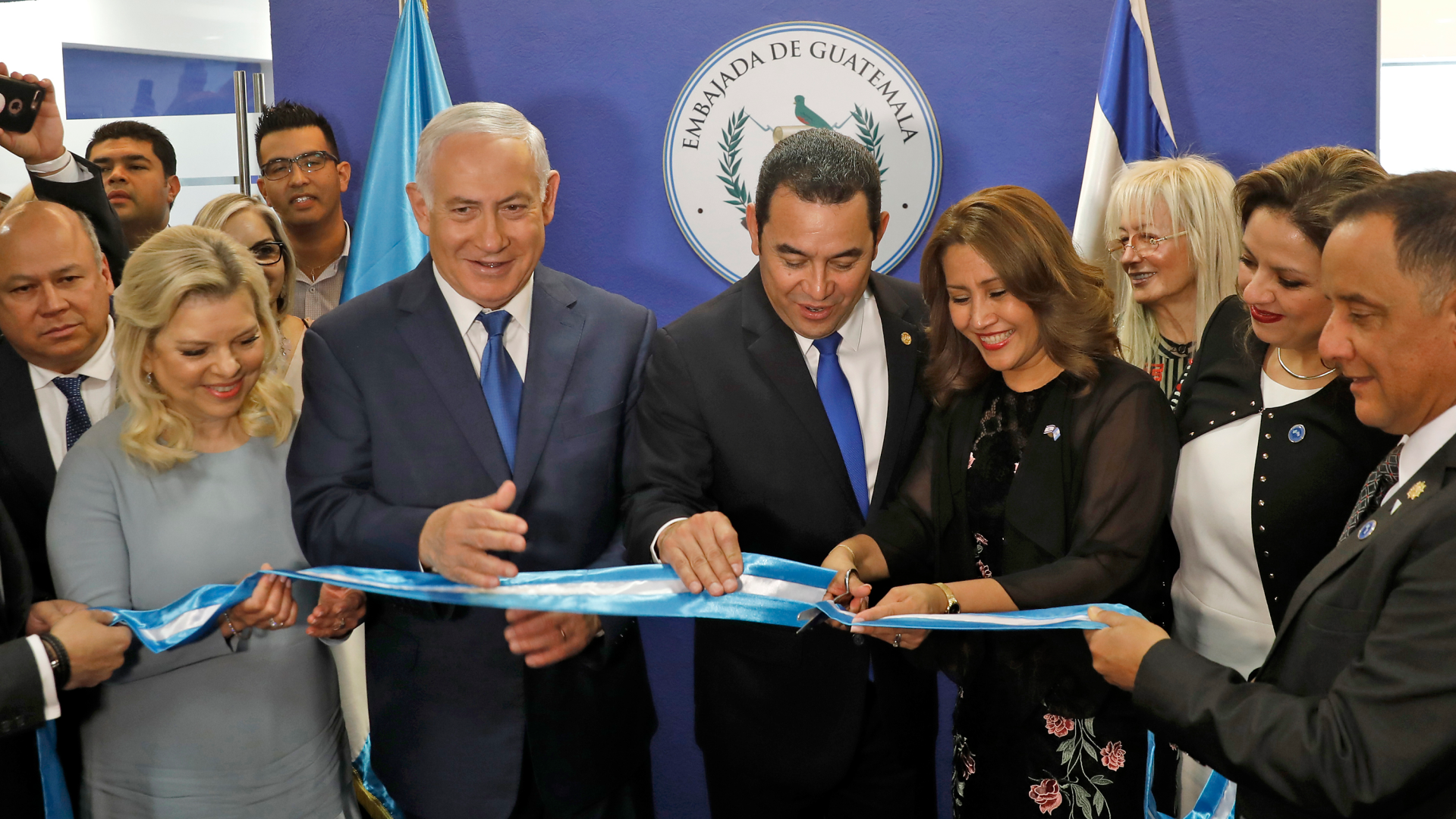 Israeli Prime Minister Benjamin Netanyahu and Guatemalan President Jimmy Morales cut the ribbon during the inauguration ceremony of the Guatemalan embassy in Jerusalem.