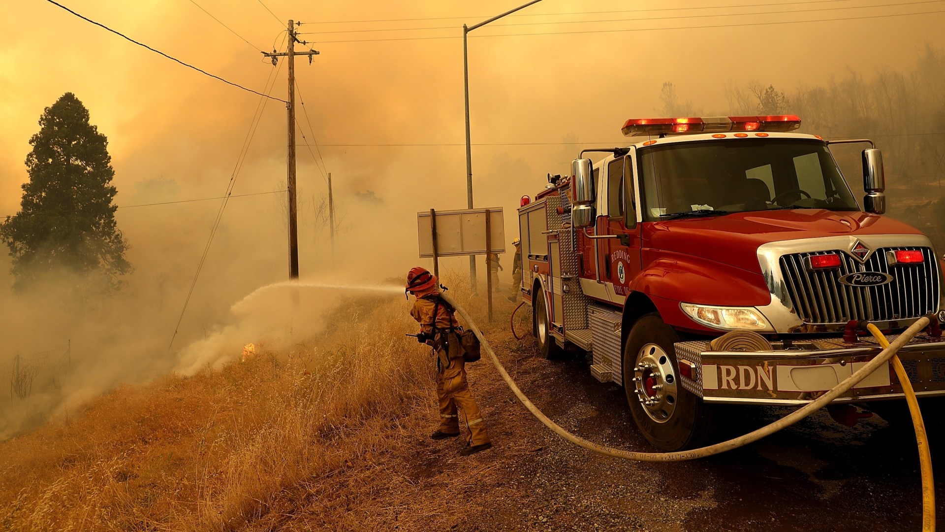 A Redding firefighter battles the Carr Fire.