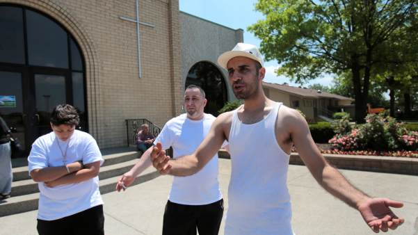 Family members rally outside Mother of God Chaldean Church in Southfield, Michigan.