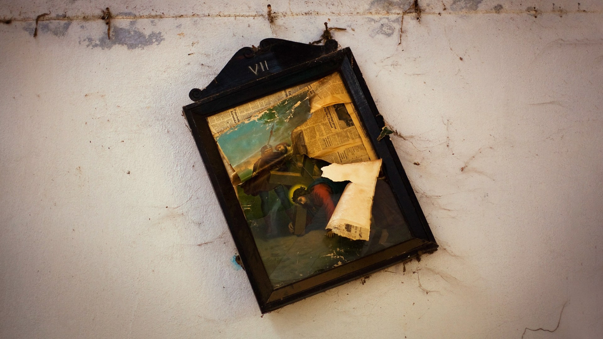 A damaged painting hangs on a the wall of a church at a relief camp in the village of Mondesore near Raikia, India