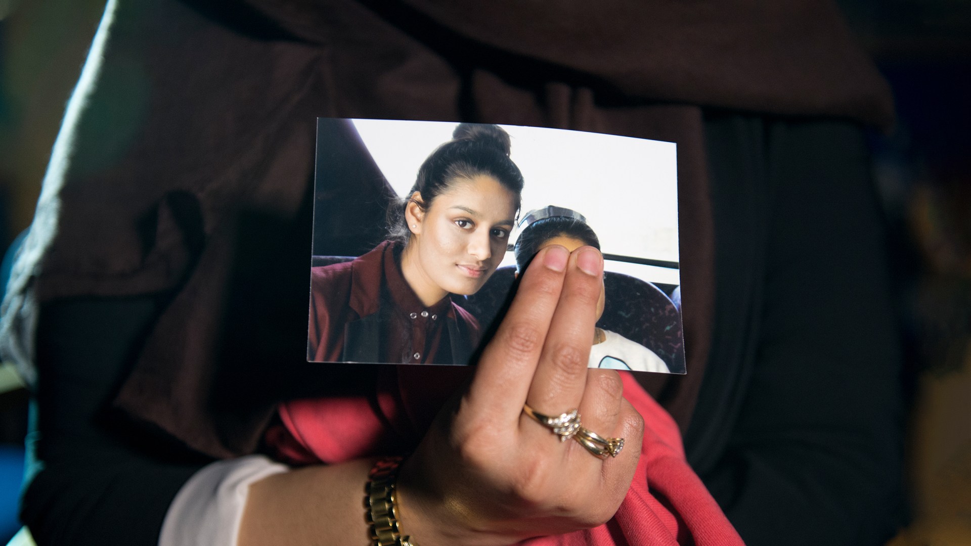 Shamima Begum is shown in a photograph held by her sister after the teenager fled London for Syria in 2015.