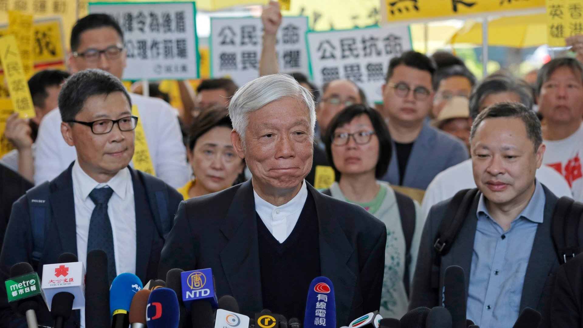 Chu Yiu-ming, center, appears with Benny Tai and Chan Kin-man before entering court to hear their verdict.