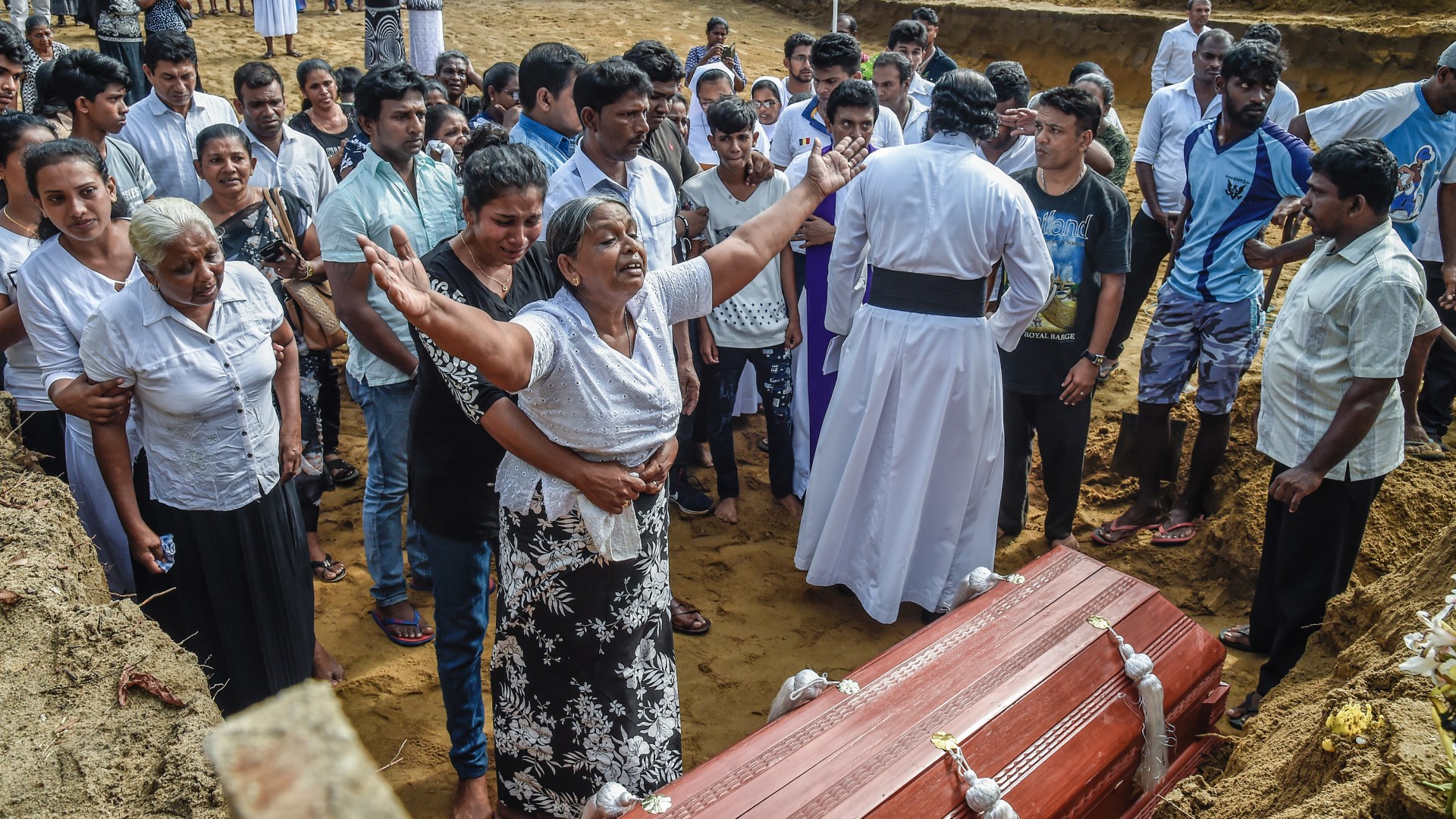 Relatives of the dead mourn during funerals in Katuwapity village on April 23 in Negombo, Sri Lanka.