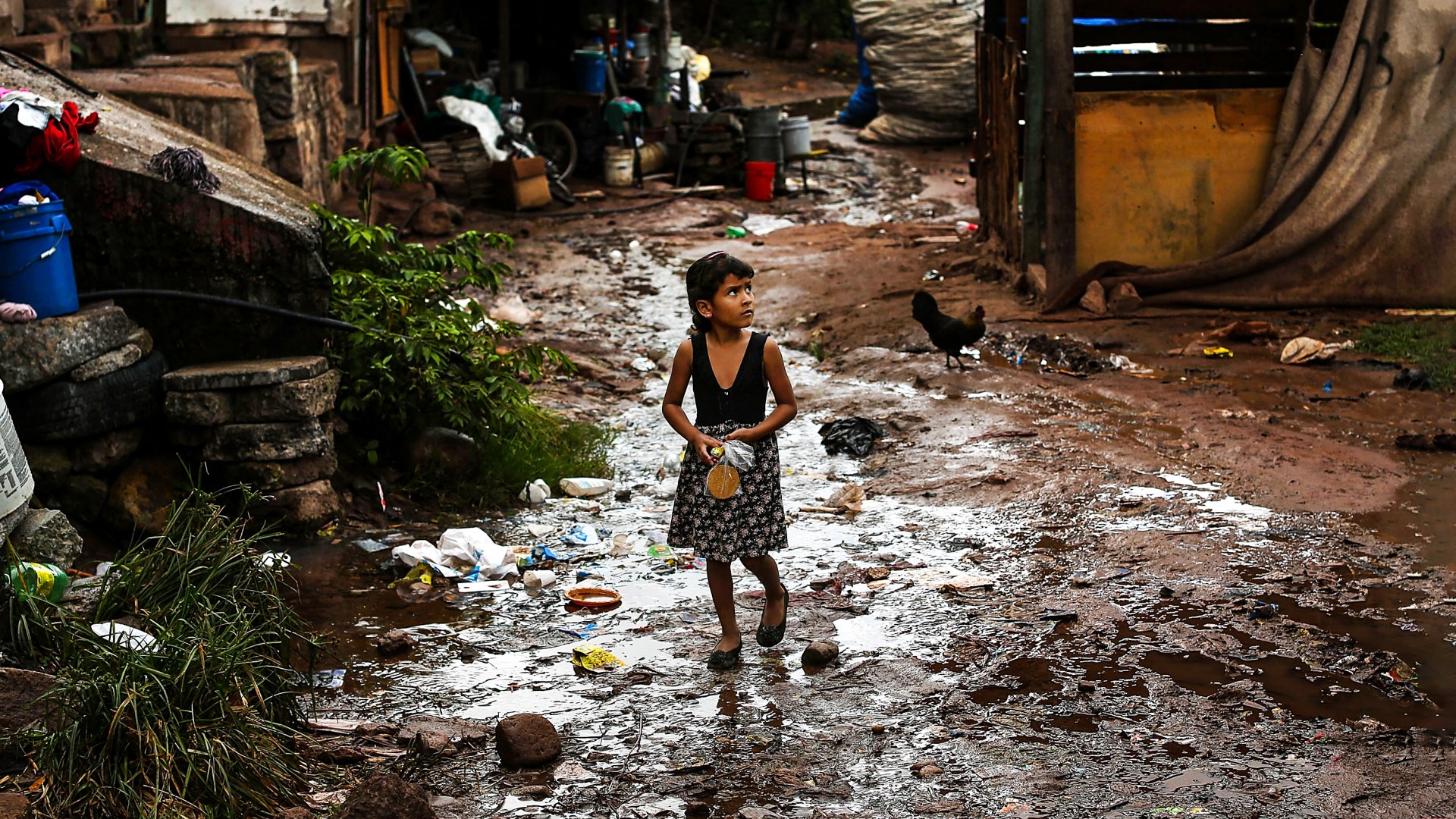A young girl walks in a neighborhood known for heavy drug dealing in Tegucigalpa, Honduras.