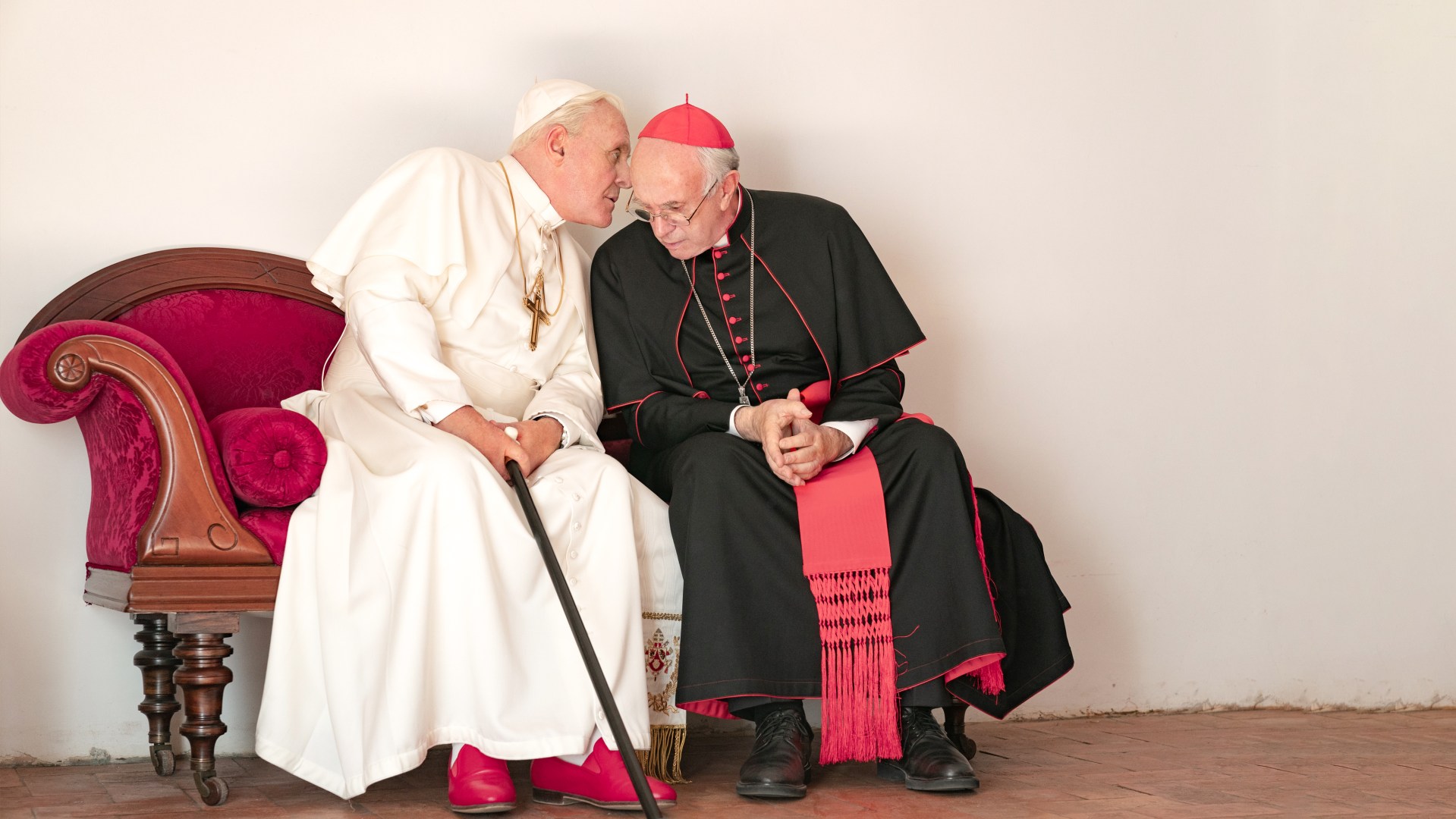 Pope Benedict (Anthony Hopkins) shares a private thought with his former antagonist, Cardinal Bergoglio (Jonathan Pryce) in a Netflix original film that releases on Netflix Dec. 20th.