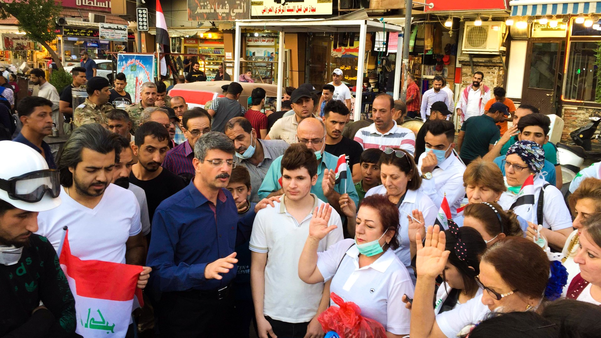 Pastor Ara Badalian leads members of National Baptist Church in prayer at Baghdad's Tahrir Square.