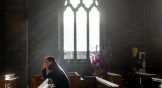 A man prays in a church on Christmas Eve in Birmingham, England.