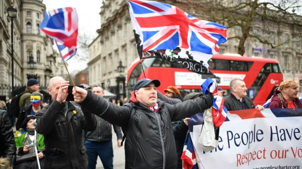Pro-Brexit supporters wave Union Jack flags at Parliament Square as people prepare for Brexit on January 31, 2020 in London, United Kingdom.