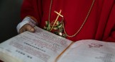 A Chinese Catholic deacon holds a bible at Palm Sunday Mass at an "underground" or unregistered church in China's Hebei province.
