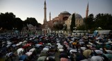 Muslims offer evening prayers outside the Byzantine-era Hagia Sophia, one of Istanbul's main tourist attractions, following the decision to reconvert it into a mosque on July 10.