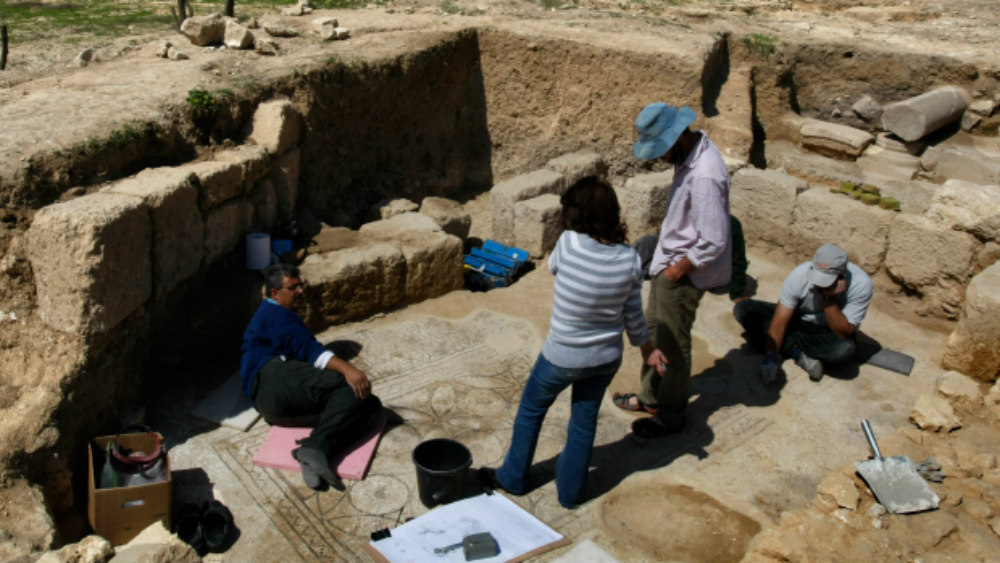 Israeli archaeologists clean a mosaic in the ruins of a church that dates back to the Byzantine period.