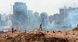 A soldier walks at the devastated site in the port of Beirut, two days after a massive explosion devastated the Lebanese capital in a disaster that has sparked grief and fury.