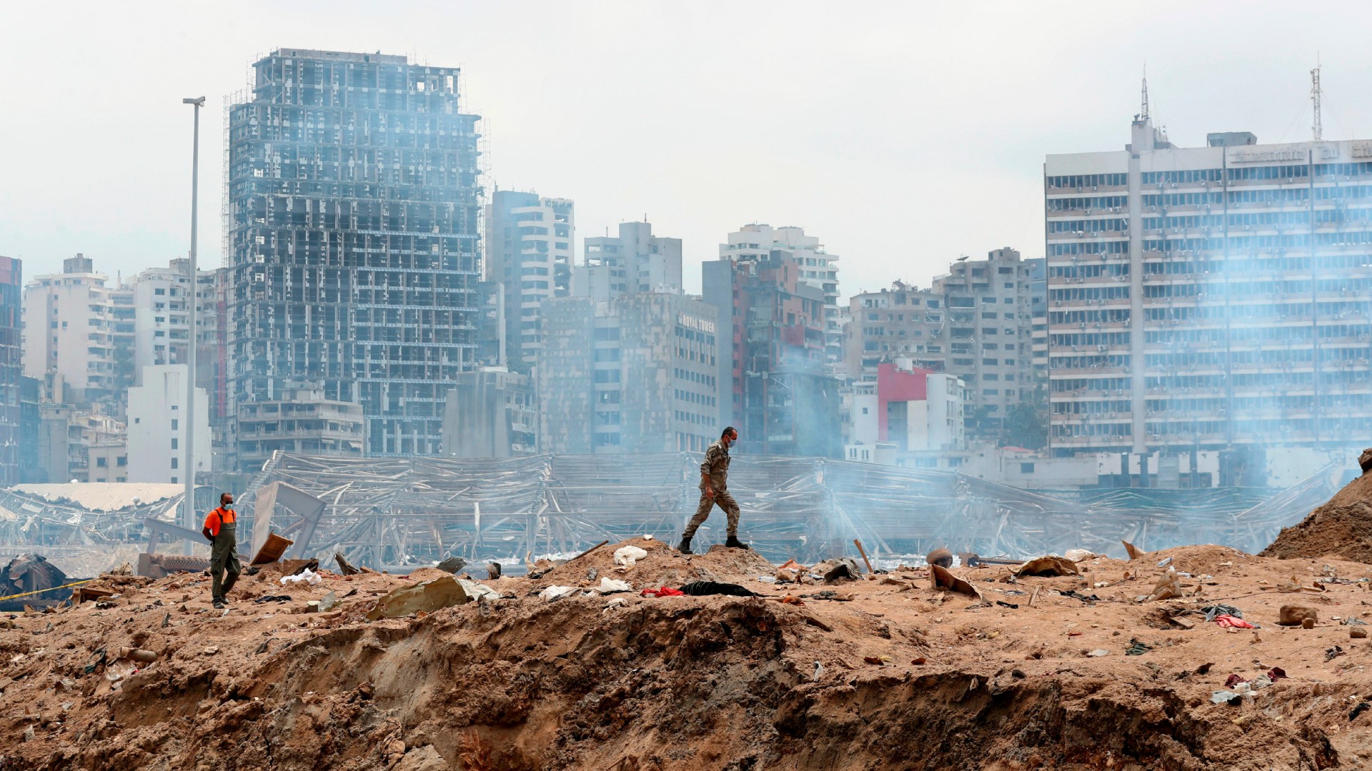 A soldier walks at the devastated site in the port of Beirut, two days after a massive explosion devastated the Lebanese capital in a disaster that has sparked grief and fury.