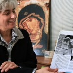 Jocelyne Khoueiry, a former Christian Maronite Phalange party fighter, looks at an iconic picture of herself holding a gun during fighting in downtown Beirut in 1975 at the height of Lebanon's civil war.