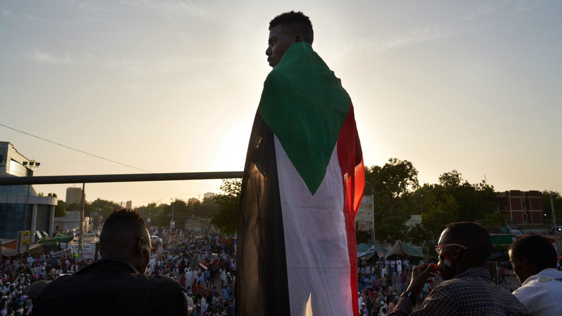 A protester draped in the Sudanese flag in Khartoum last year.