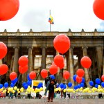 A woman places balloons with the colors of the Colombian national flag at Bolivar Square in Bogota on October 2 during a symbolic act commemorating the fourth anniversary of the referendum held to ratify a historic peace accord between the Colombian government and the FARC guerrillas, which voters narrowly rejected.