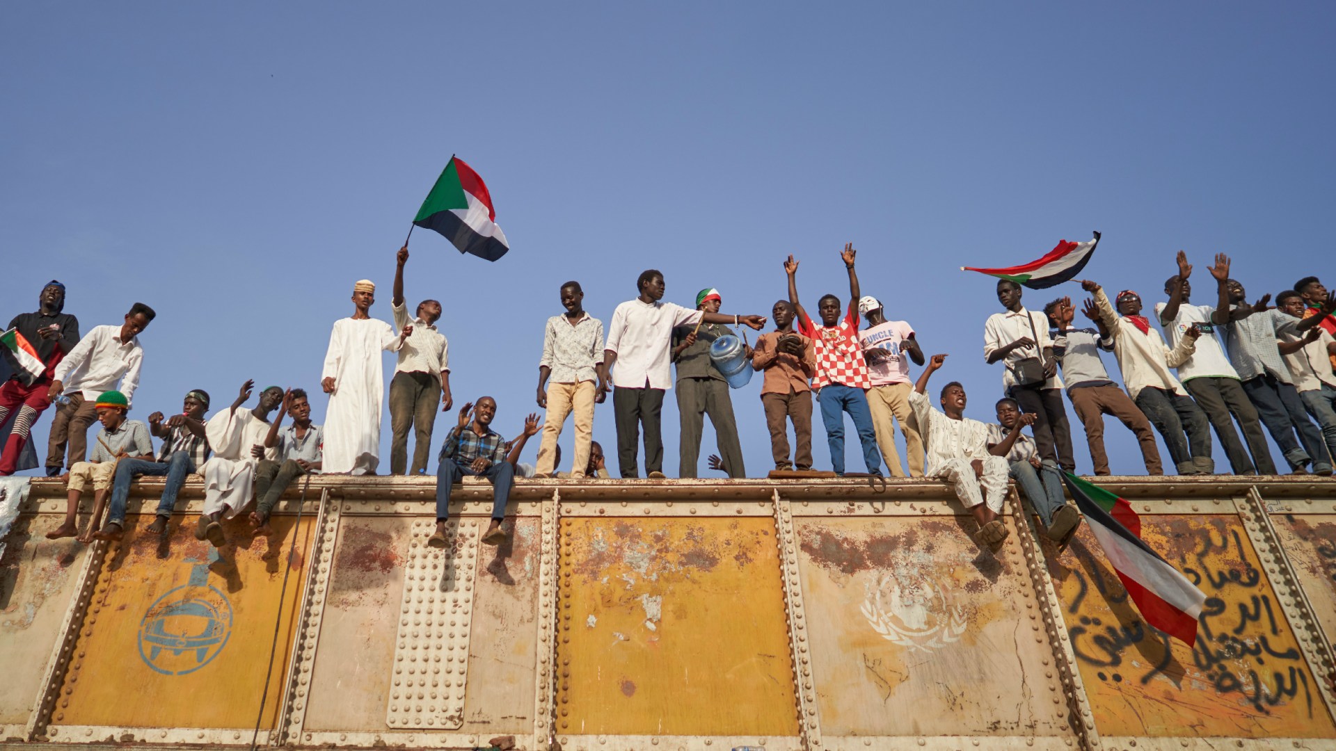 Protesters chant from a railroad track in May 2019 above a mass sit-in outside military headquarters in Khartoum to call on the country's military rulers to cede control.