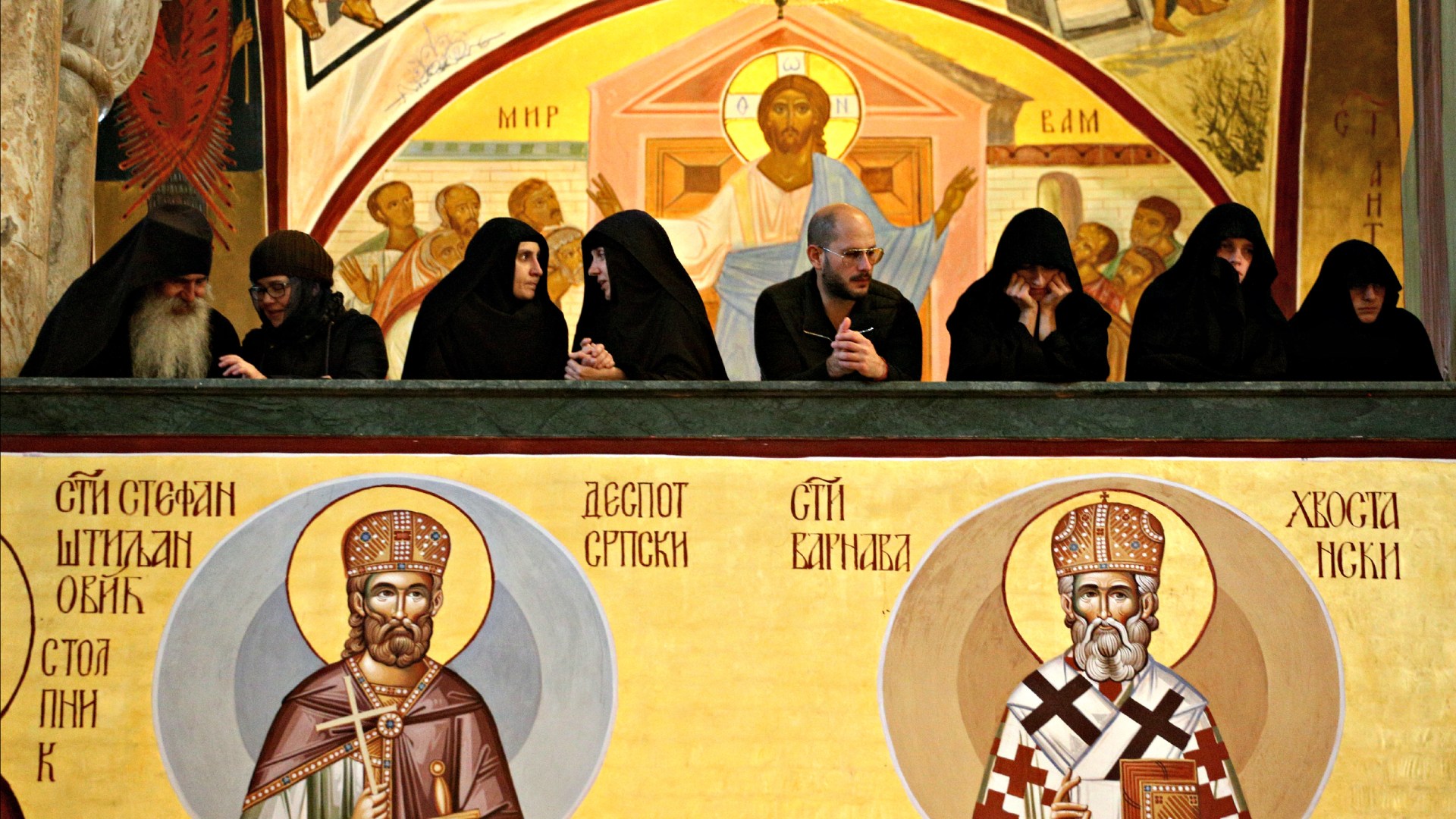 Priests and Orthodox nuns watch the funeral service for Metropolitan Amfilohije Radovic from the balcony on November 1, 2020 in Podgorica, Montenegro.