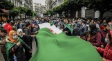 People in Algiers wave a big Algerian flag during a protest held today to mark the second anniversary of the mass demonstrations, commonly known as the Hirak Movement, that pushed long-time ruler Abdelaziz Bouteflika out of office in April 2019.