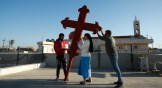 Iraqi Christians place a cross on a church in Qaraqosh on February 22 in advance of Pope Francis' visit to Iraq next month.