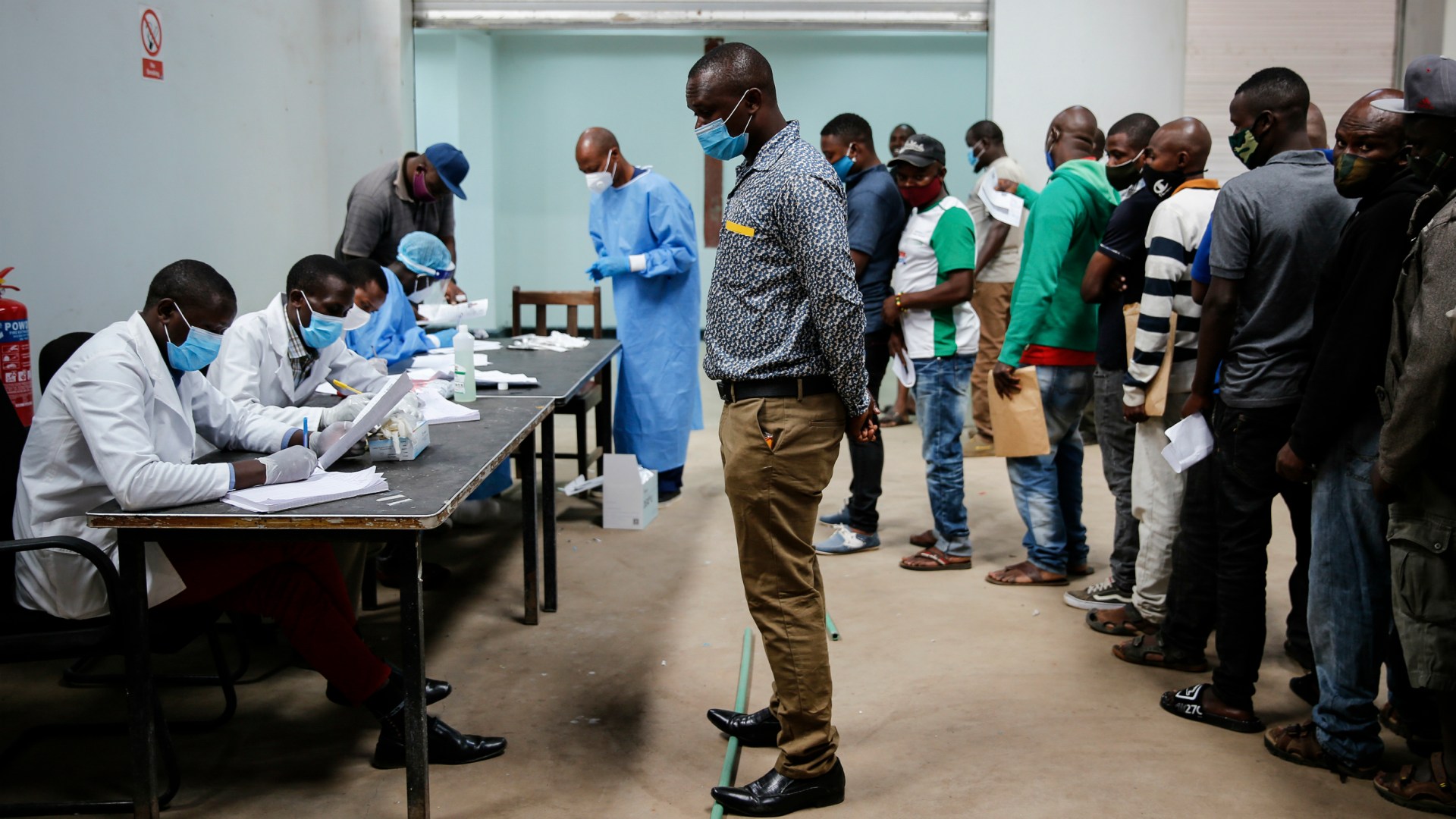 Truck drivers get screened for COVID-19 at Tanzania's border with Kenya.