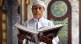 A Muslim reads the Quran in an Indonesian mosque.