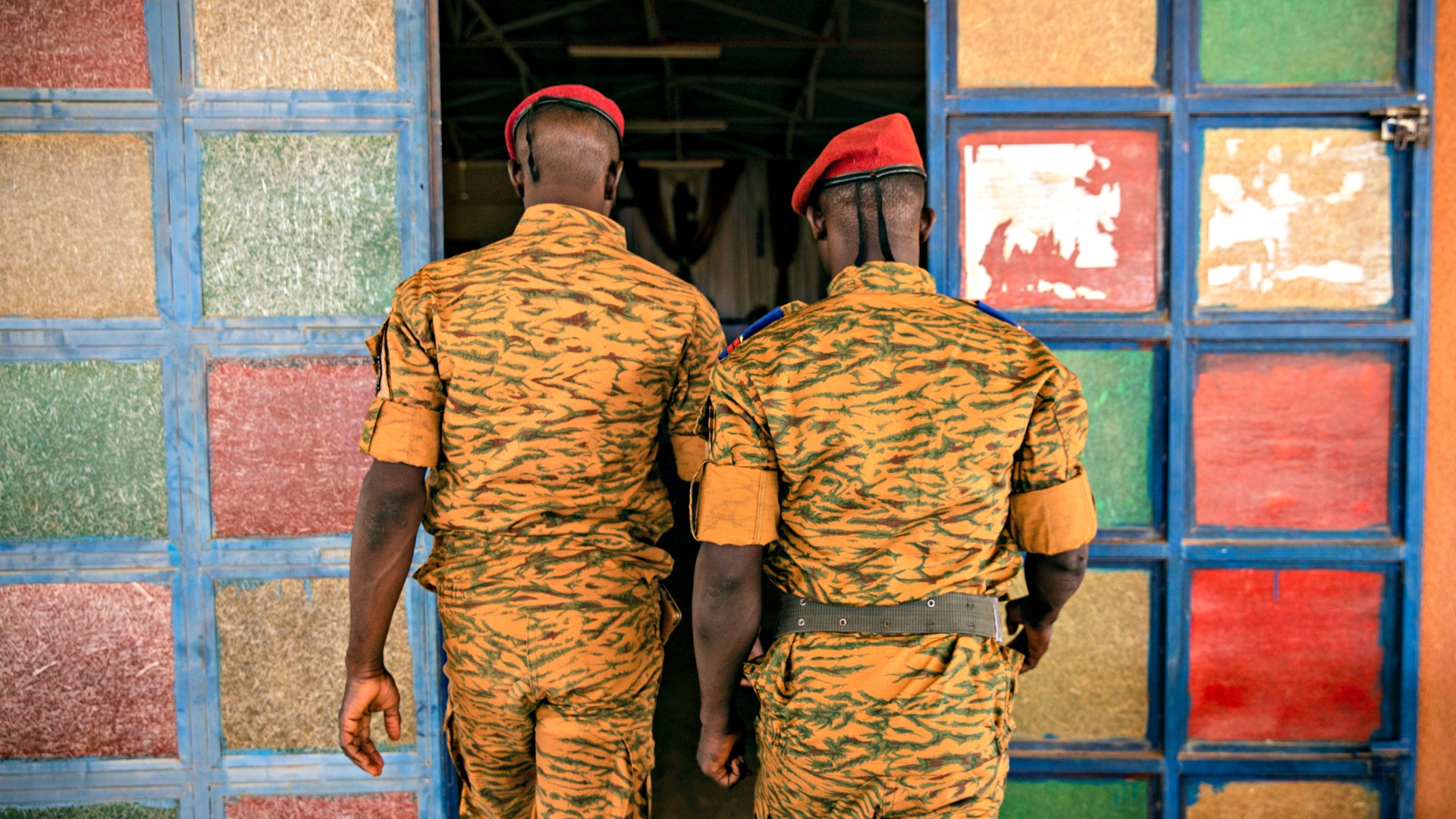 Two soldiers enter the Catholic church at the 10th RCAS army barracks in Kaya, Burkina Faso on April 10.